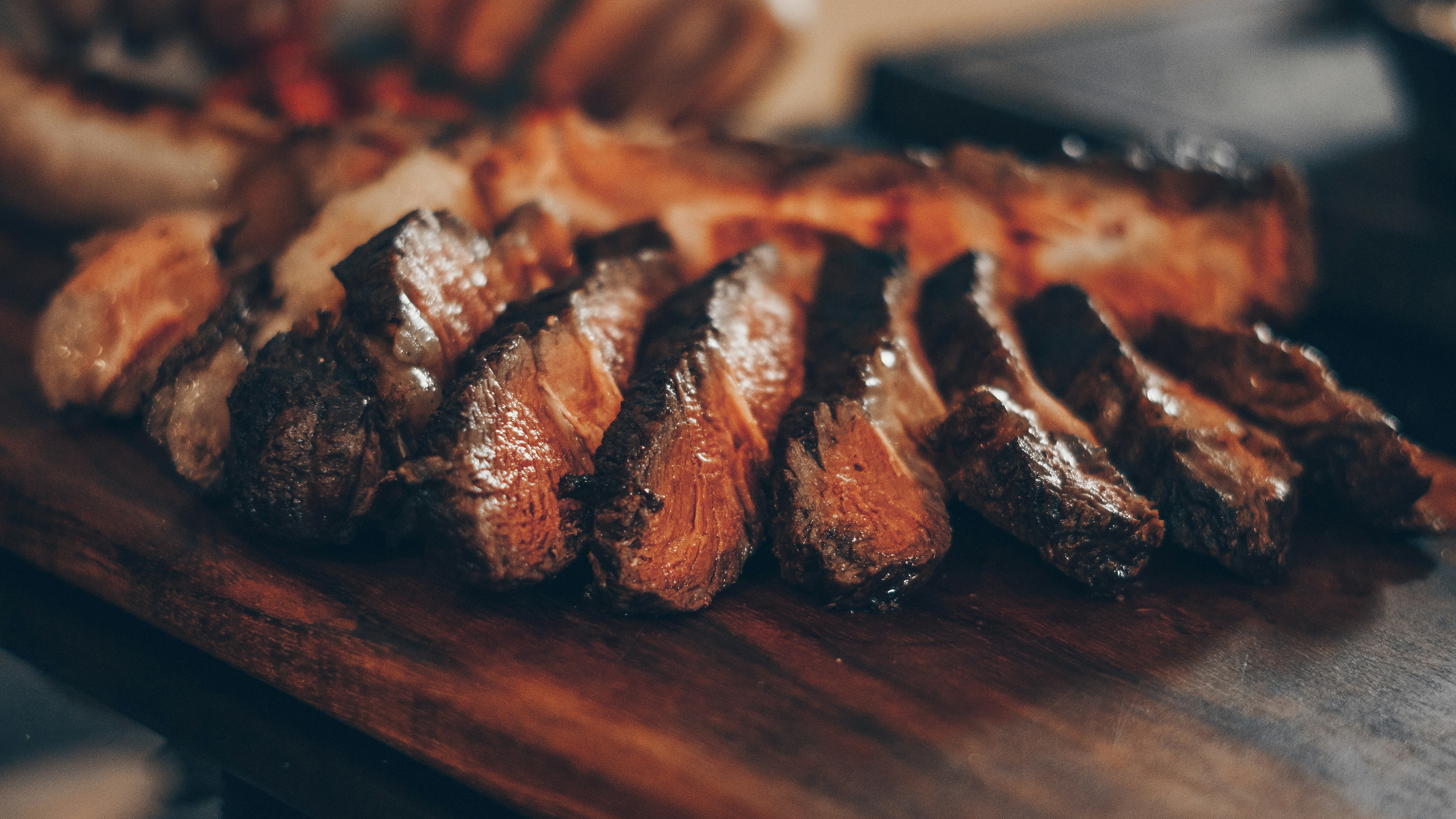 A picture of cooked and sliced steak.